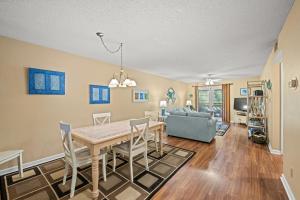 a dining room and living room with a table and chairs at Heron Pointe C8 in Myrtle Beach