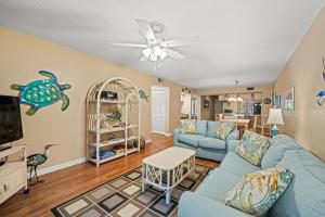 a living room with a blue couch and a tv at Heron Pointe C8 in Myrtle Beach
