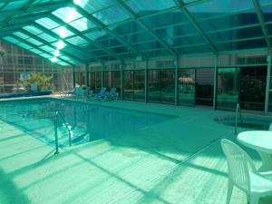 a large swimming pool with chairs and a table at Heron Pointe C8 in Myrtle Beach