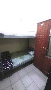 a small room with two bunk beds in it at Bunk bed private room Avani in Dubai