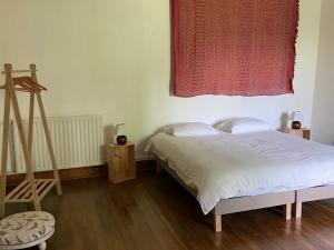 a bedroom with a bed and a window and a ladder at La Colline aux Licornes in Montbron