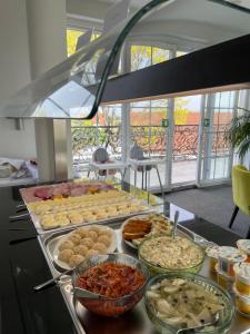 a buffet with many different types of food on a table at Apartamenty M&M in Mikołajki