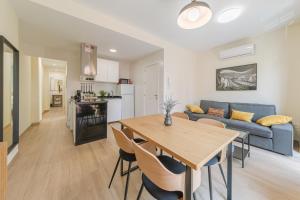 a living room with a table and a blue couch at Bosco Eco Living in Seville