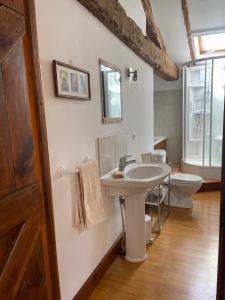 a bathroom with a sink and a toilet at La Colline aux Licornes in Montbron