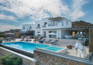 a villa with a swimming pool and a horse statue in front of it at Ethereal Villa Mykonos in Kalafatis