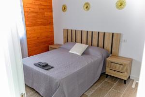 um quarto com uma cama e uma cabeceira em madeira em Casas Cristea em Cehegín