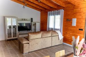 a living room with a couch and a television at Casas Cristea in Cehegín