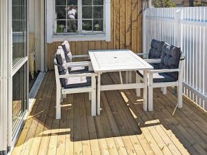 a white table and two chairs on a deck at Holiday home HÖLLVIKEN III in Höllviken