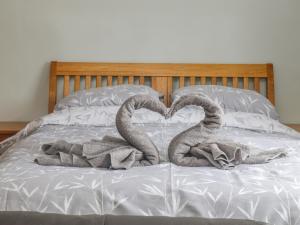 two snakes laying on a bed in the shape of a heart at The Pool House in Crediton
