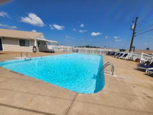 a large blue swimming pool in front of a house at Lakefront condo with a VIEW Osage Beach in Osage Beach