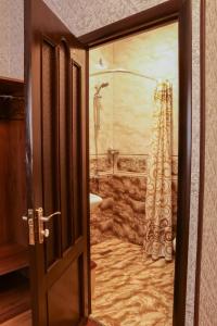 an open door to a bathroom with a shower at Styopa Hotel in Yerevan