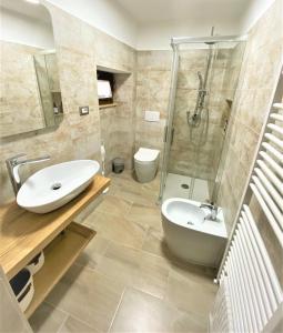 a bathroom with a sink and a shower and a toilet at Podere La Selva in Rapolano Terme