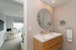 a bathroom with a sink and a mirror at Luxury Lookout - Cable Bay Holiday Home in Cable Bay +25 photos