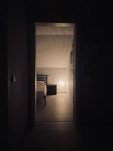 a dark room with a door leading to a bedroom at ViiLa TO in Bertea