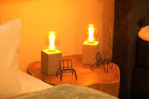 2 luces en una mesa con sillas en una cama en Galerie-Wohnung I Europapark 15 min I Boxspring I New, en Kippenheim