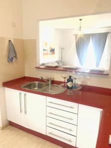 a kitchen counter with a sink and a window at A cozy staying in the heart of Lanzarote. in San Bartolomé