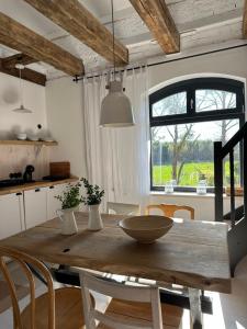 a wooden table in a kitchen with a large window at Ublik Stacja in Ublik +94 photos