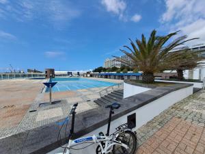 una bicicleta estacionada junto a una piscina en SolMar View Apartment, Azores en Ponta Delgada