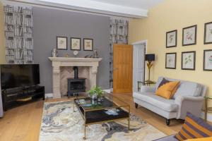 a living room with a couch and a fireplace at Tarn End Cottage with view to Talkin Tarn, near Lake District in Brampton