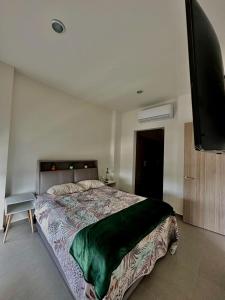 a bedroom with a bed and a flat screen tv at Departamento en Mazatlán Torre Zuñiga in Mazatlán +12 photos