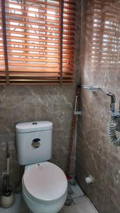 a bathroom with a white toilet in a room at Keev Homes & Apartments Shortlet in Port Harcourt