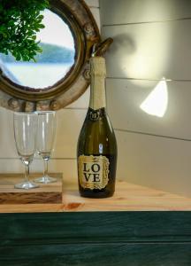 a bottle of wine sitting on a table next to two glasses at Saimaa Experience in Savonlinna