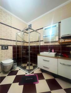 a bathroom with a shower and a sink and a toilet at Seabird Suite Apart Hotel in Trabzon +32 photos
