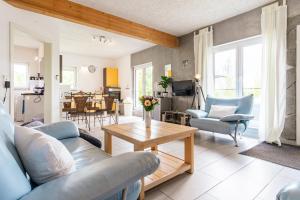 a living room with a couch and a table at Eifel-Apartments Orsfeld in Orsfeld