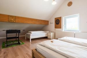 a bedroom with two beds and a desk in it at Eifel-Apartments Orsfeld in Orsfeld