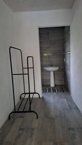 a bathroom with a sink and two chairs in a room at Nanisto Bush Lodge in Marloth Park