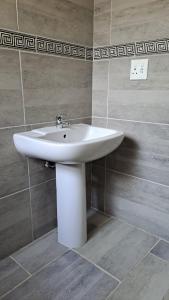 a bathroom with a white sink in a room at Nanisto Bush Lodge in Marloth Park