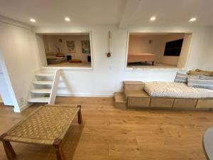 a living room with a bed and a stair case at Modern Apartment w/ Private Deck & BEAUTIFUL VIEWS in Topanga