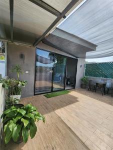 an open patio with a table and potted plants at Los Portones de Ataco in Concepción de Ataco