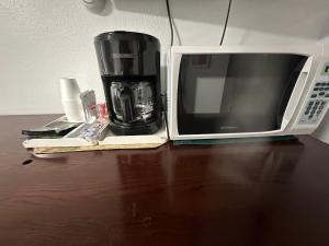 a coffee maker and a microwave on a table at Fossil Butte Motel in Kemmerer