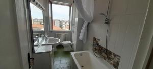 a bathroom with a tub and a sink and a toilet at I feel orange in Legnano +61 photos