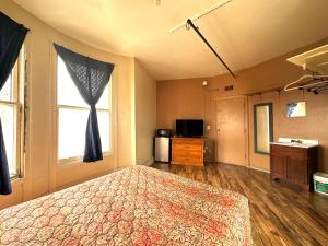 a bedroom with a large bed and a window at Entella Hotel in San Francisco