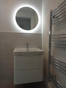 a bathroom with a sink and a mirror at The Cottage - Fairwinds in Doolin