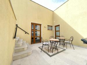 a patio with tables and chairs in a building at Angolo Di Dante in Nardò