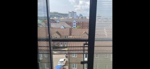 a view of a city from a window at 2bed luxury modern apartment in Swansea