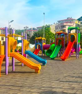 a playground with colorful slides in a park at Seabird Suite Apart Hotel in Trabzon