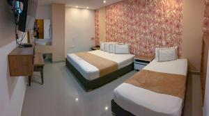 Voodi või voodid majutusasutuse Infinity Hotel toas