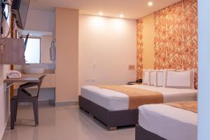 Voodi või voodid majutusasutuse Infinity Hotel toas