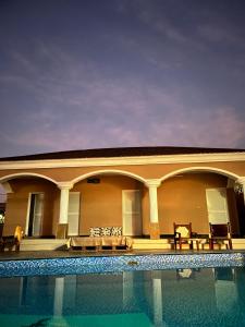 a house with a swimming pool in front of it at Haramous Guest House in Djibouti