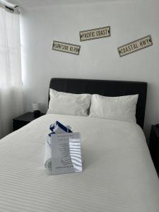 a white bed with a box on top of it at Peaceful Luxury Villa - TheShine&GlowPlace in Fajardo