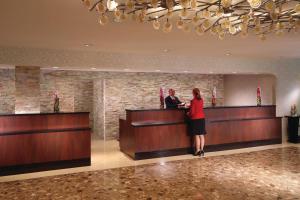 a woman standing at a counter in a hotel lobby at Atlanta Airport Marriott in Atlanta