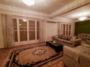 a living room with a couch and a table at Nile view apartment in Cairo