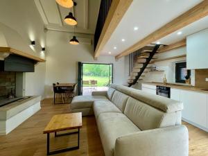 a living room with a couch and a table at Villa Ondina - private pool in Brtonigla