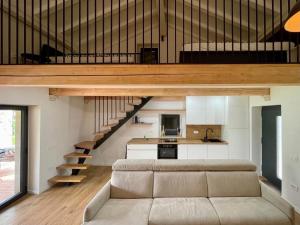 a living room with a couch and a loft at Villa Ondina - private pool in Brtonigla +9 photos