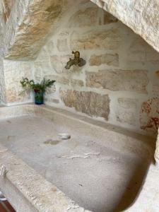a teddy bear on the wall of a stone wall at Villa Ondina - private pool in Brtonigla