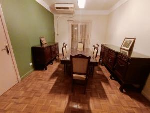 a room with a table and chairs in a room at Nile view apartment in Cairo